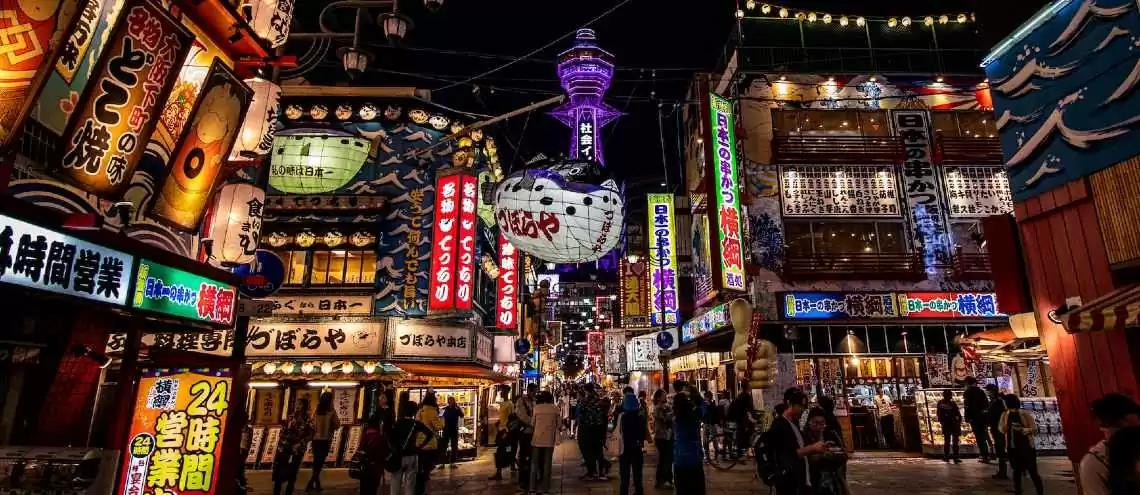 This is the Dotonburi district, one of the most popular and beloved areas in Osaka. You can find many restaurants, street food vendors, and shops along the street. 