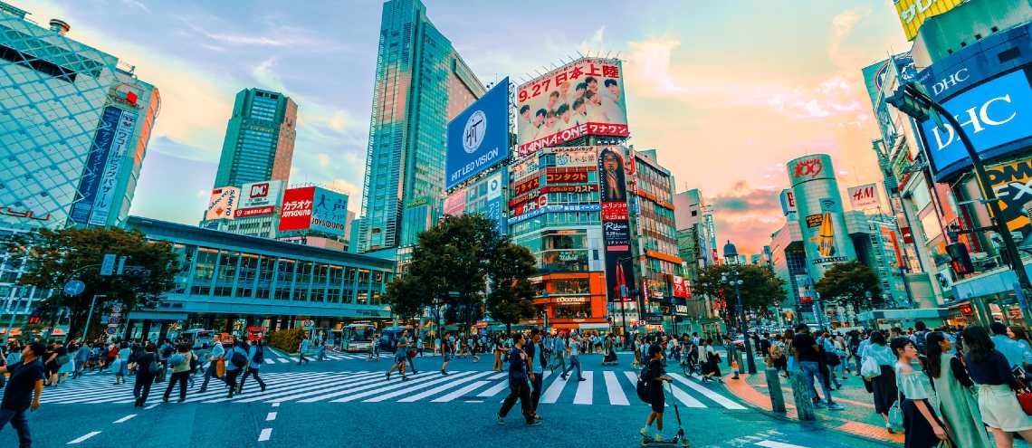 Pedestrians are in a rush to cross the road at the famous Shibuya crossing in Tokyo. 