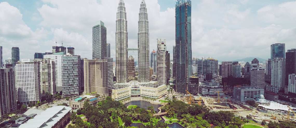 Kuala Lumpur Malaysia skyline with the Petronas Twin Towers and a park