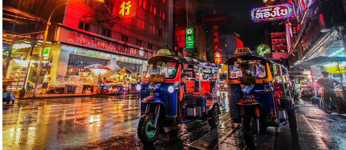 Tuk tuk in Chinatown with colorful street lights in Bangkok Thailand 