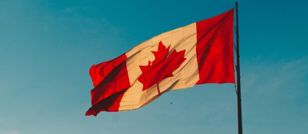 Canadian flag with the sky as the backdrop
