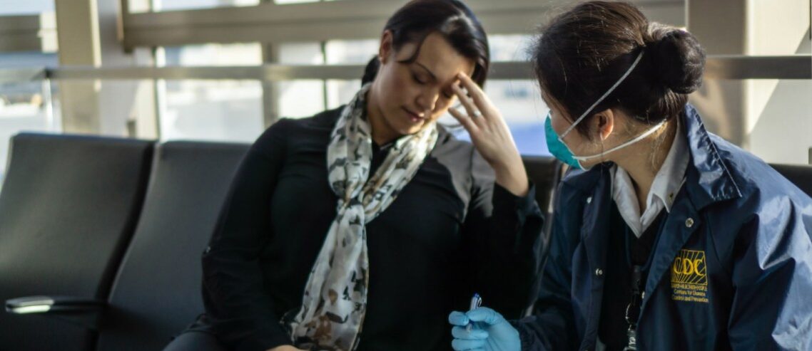 Stressed woman sitting with medical staff