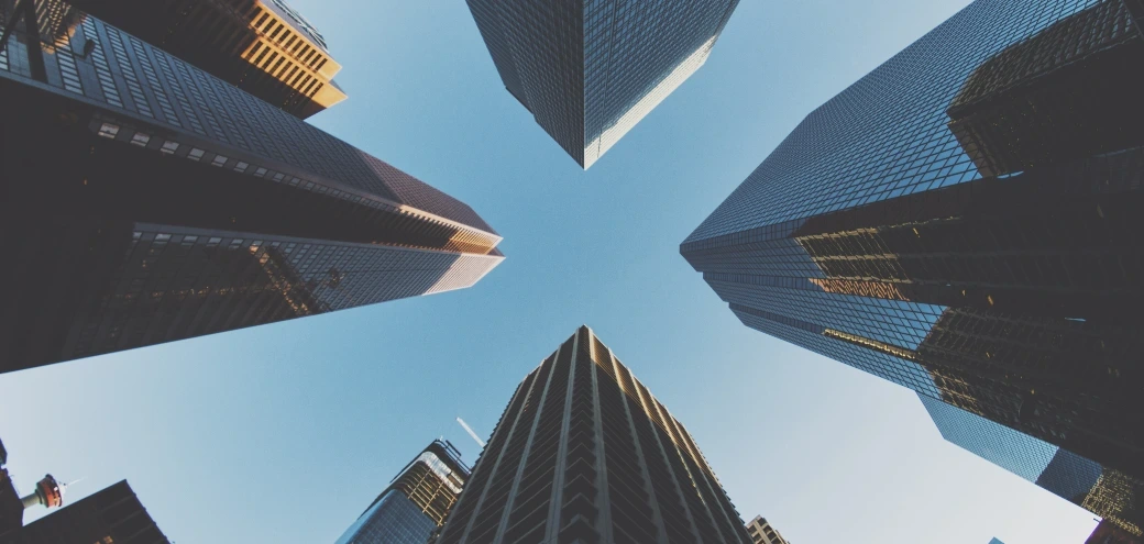 Tall buildings reflecting the clear blue sky