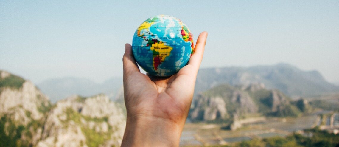 Hand holding globe