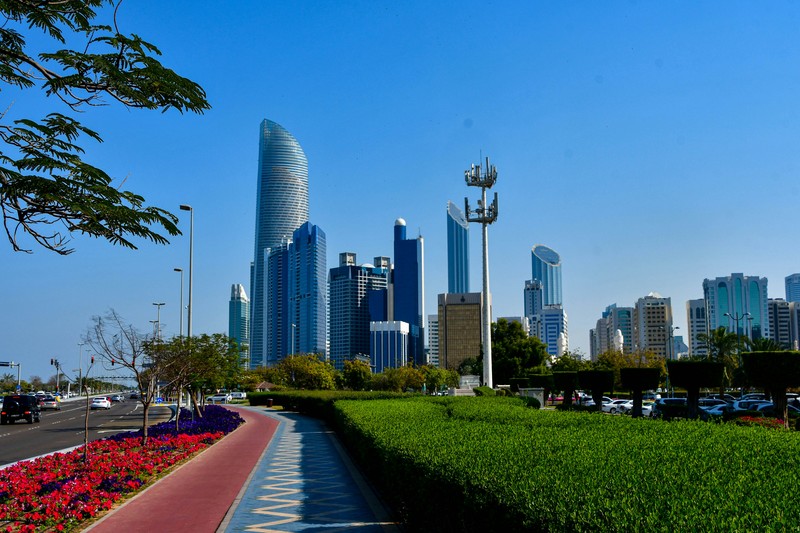 Abu Dhabi Skyline With Cars And Sidewalk, Epitome Of City Living