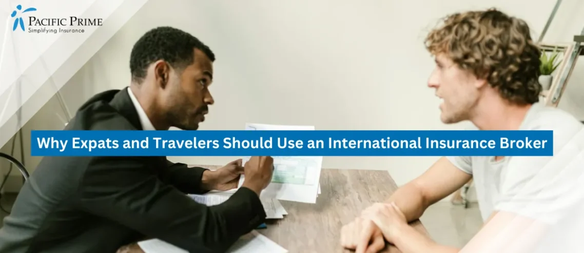 Image of Advisor And Client Reviewing Documents Together In A Modern Office Setting with text overlay of "Why Expats and Travelers Should Use an International Insurance Broker"