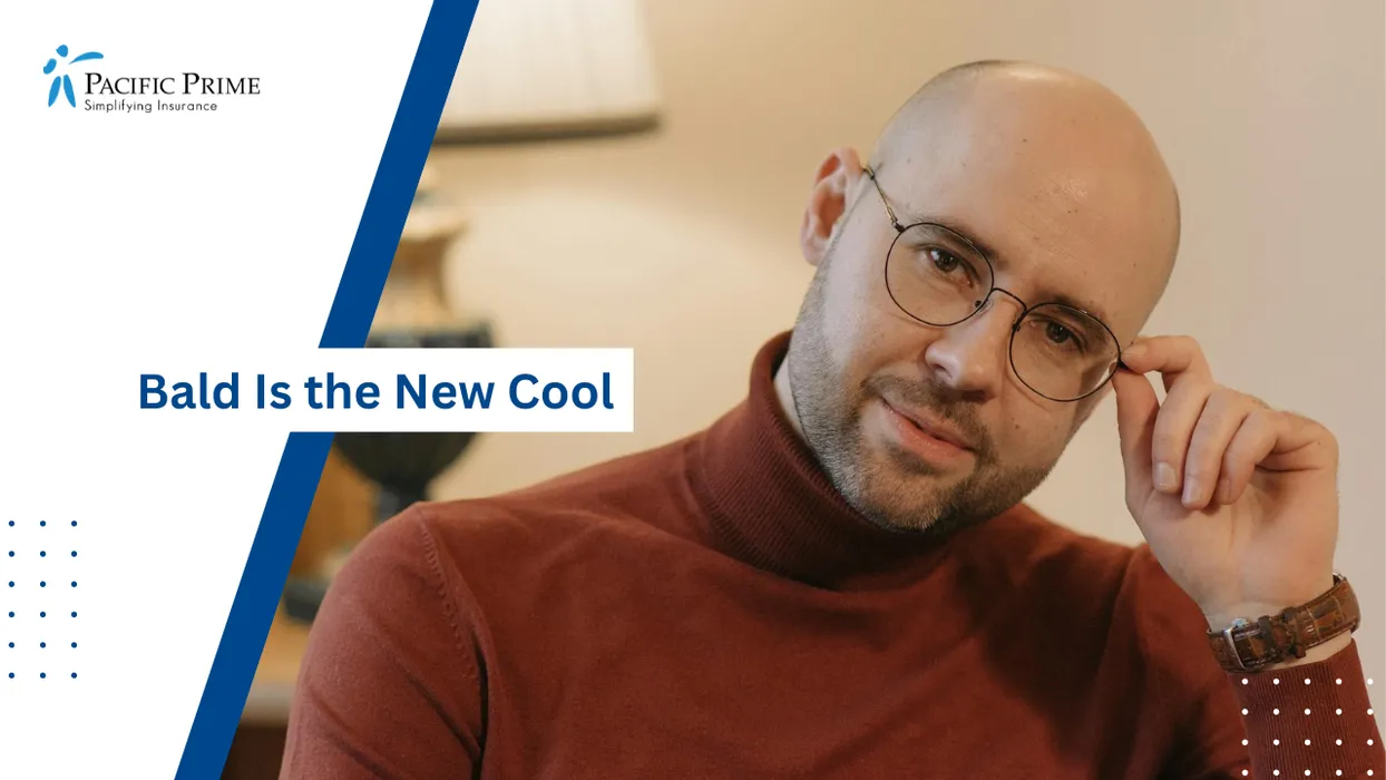 Image of Bald Man In A Brown Turtleneck Smiles While Adjusting His Glasses Indoors with text overlay of "Bald Is the New Cool"