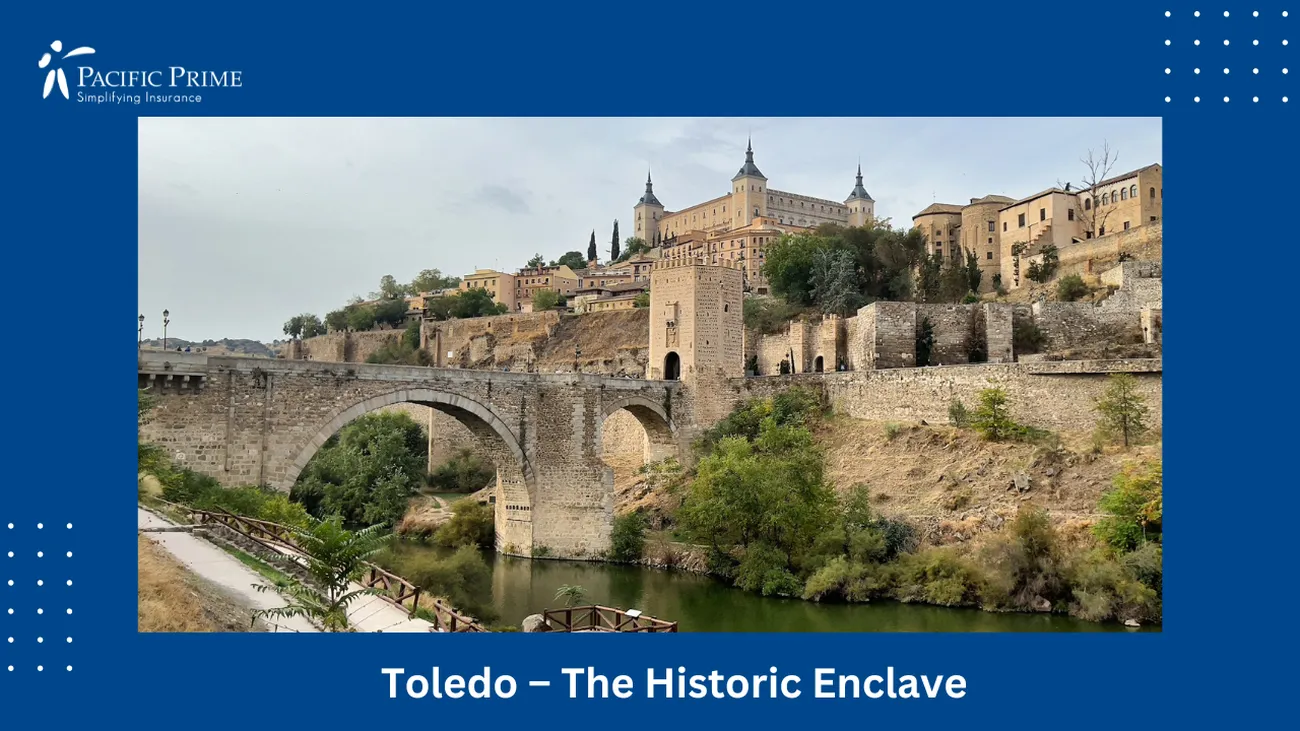 Image of Bridge Over River With Castle Backdrop In Toledo, Spain with text overlay of "Toledo – The Historic Enclave"