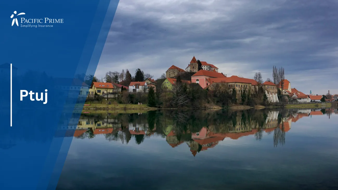 Image of Brown & White Concrete House By Water Under Gray Skies In Ptuj, Slovenia with text overlay of "Ptuj"