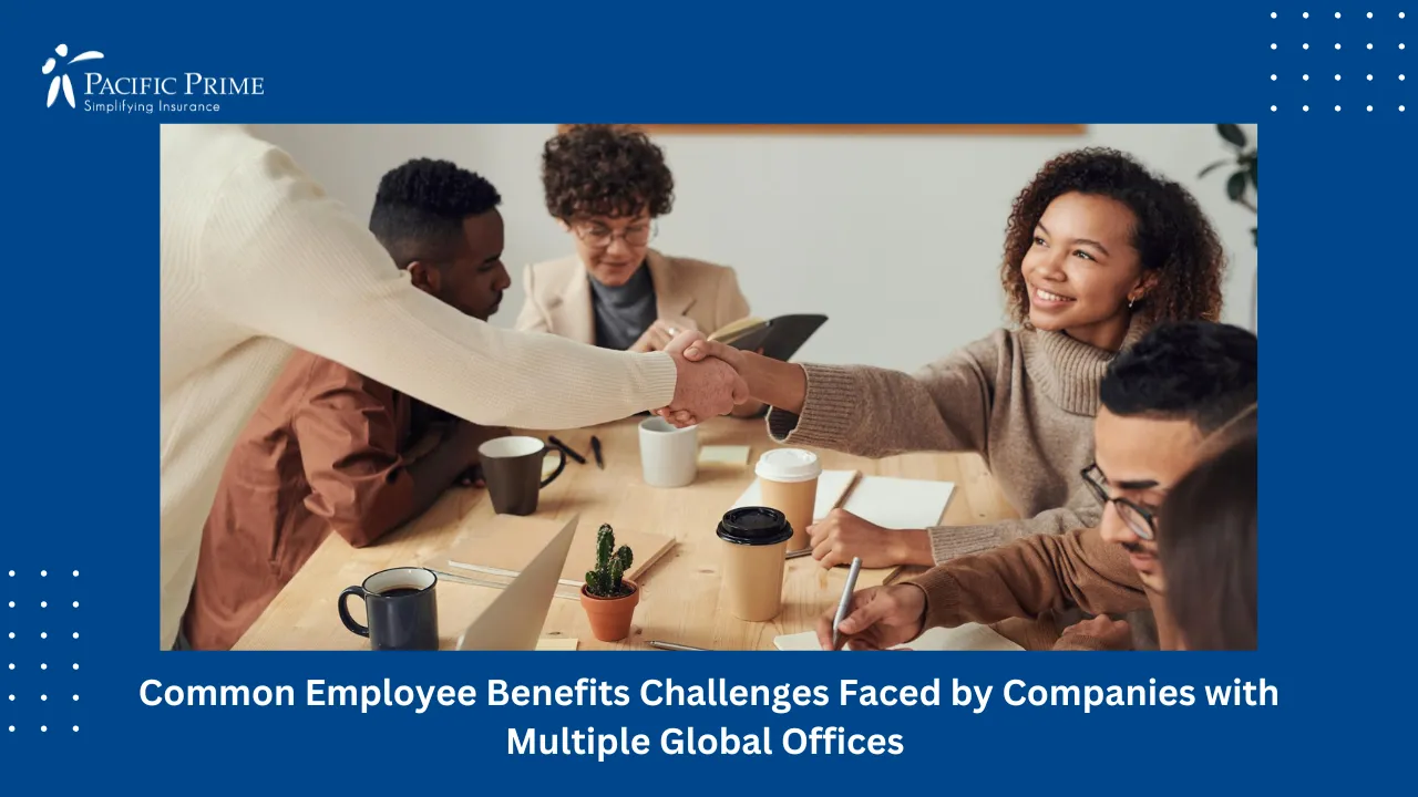 Image of Business Colleagues Smiling And Shaking Hands During A Meeting Indoors with text overlay of "Common Employee Benefits Challenges Faced by Companies with Multiple Global Offices"