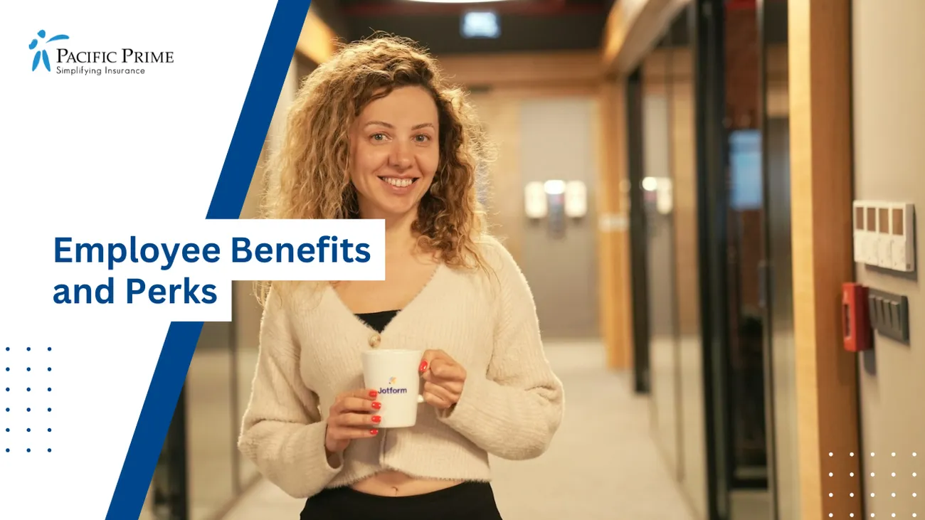 Image of Businesswoman In Hallway Holding Coffee, Standing In Office Lobby with text overlay of "Employee Benefits and Perks"