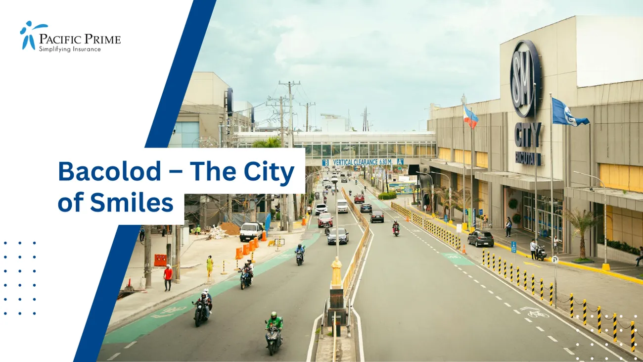 Image of City Street Bustling With Cars And Motorcycles In Bacolod, Philippines with text overlay of "Bacolod – The City of Smiles"