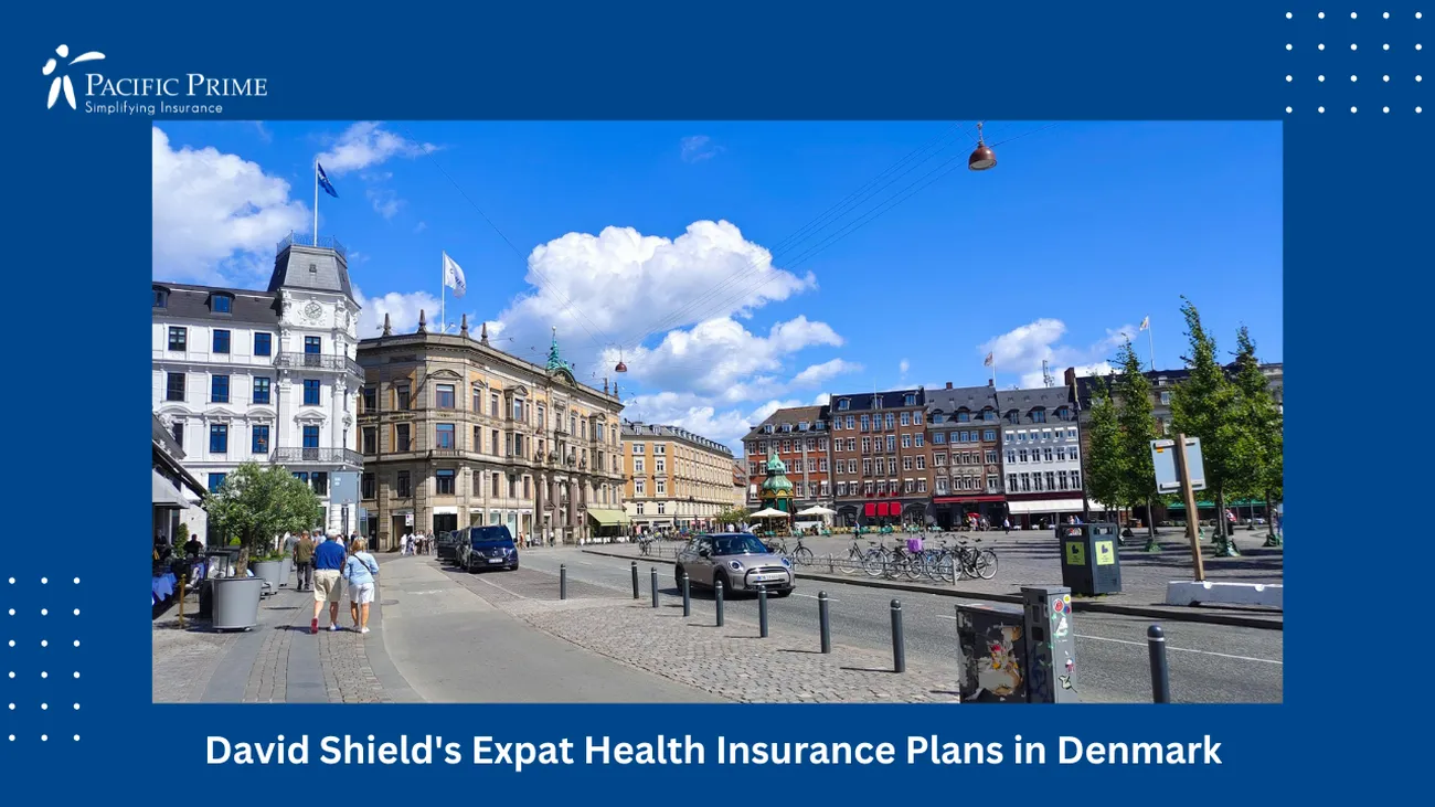 Image of City Street In Copenhagen, Denmark, With Tall Buildings And Pedestrians with text overlay of "David Shield's Expat Health Insurance Plans in Denmark"