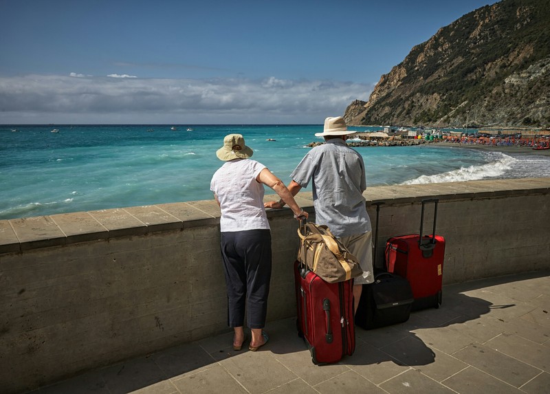 Couple By Seawall At Monterosso Beach, Italy, Senior Travel