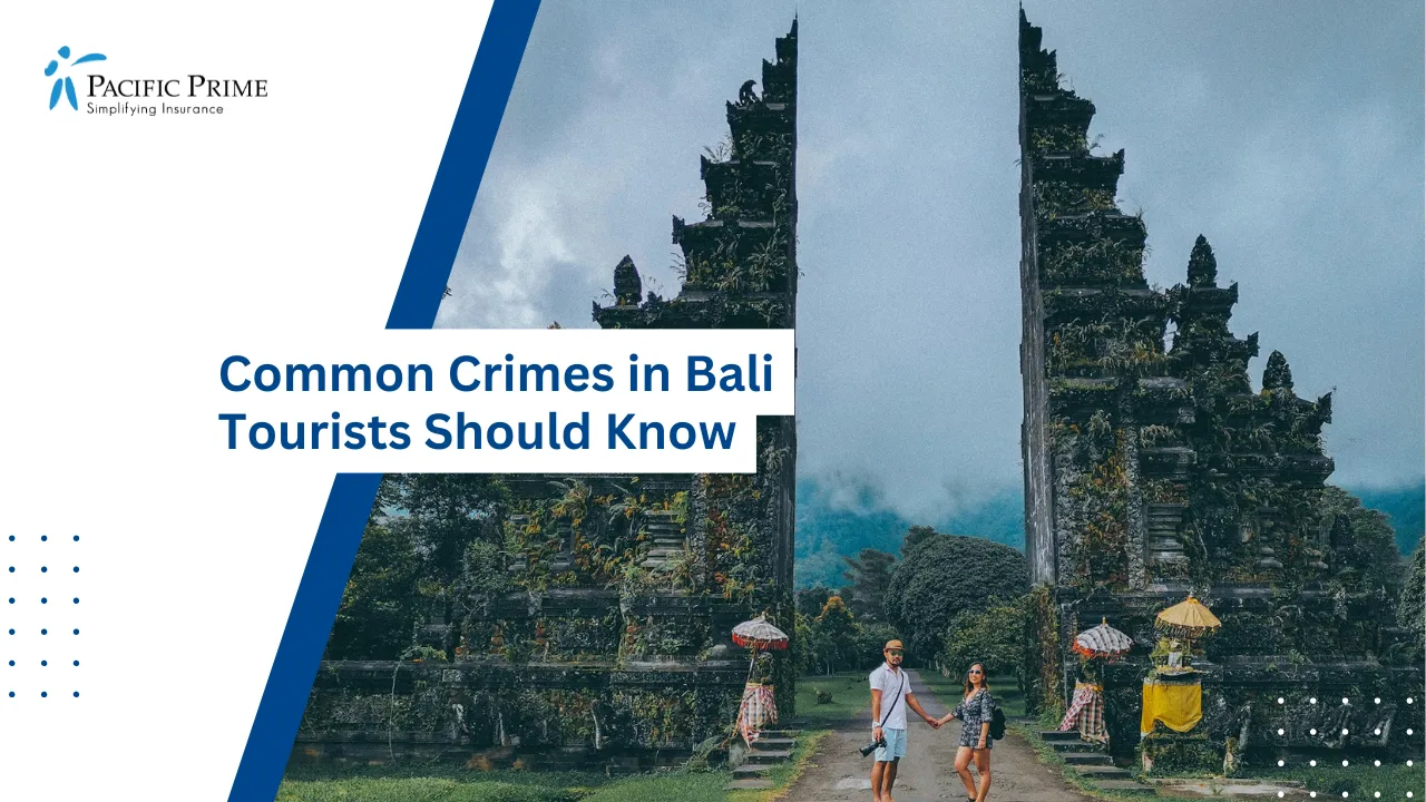 Image of Couple Strolling Between The Towering Stone Pillars Of Bali Handara Gate with text overlay of "Common Crimes in Bali Tourists Should Know"