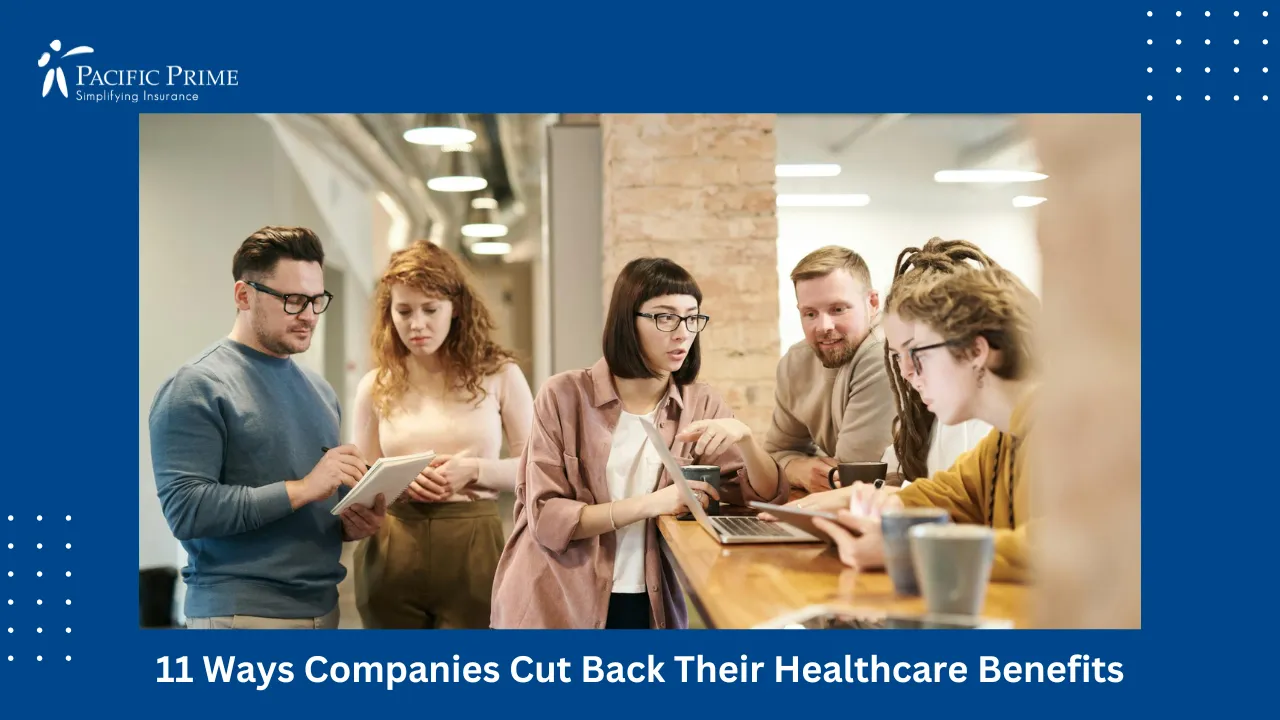 Image of Coworkers Collaborating With Tech Devices In Modern Office Environment with text overlay of "11 Ways Companies Cut Back Their Healthcare Benefits"