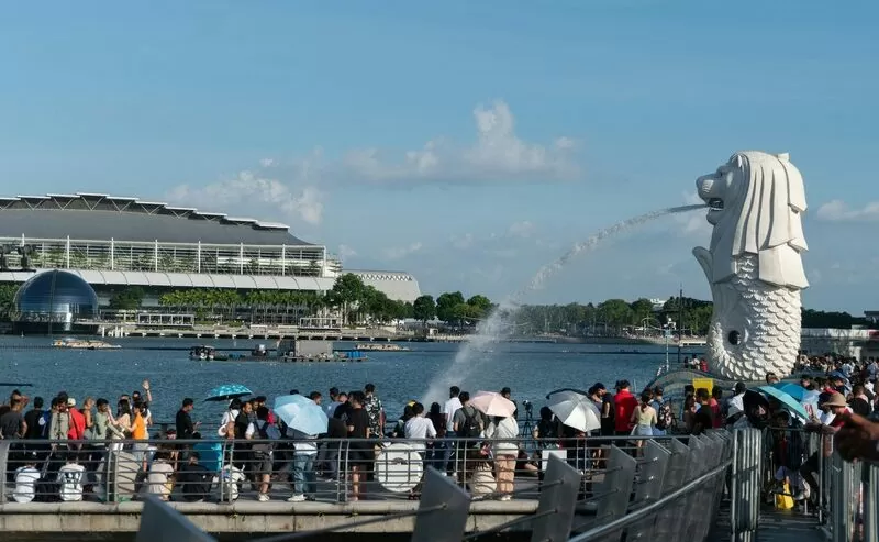 Crowd On Pier By Water Near Merlion, Singapore