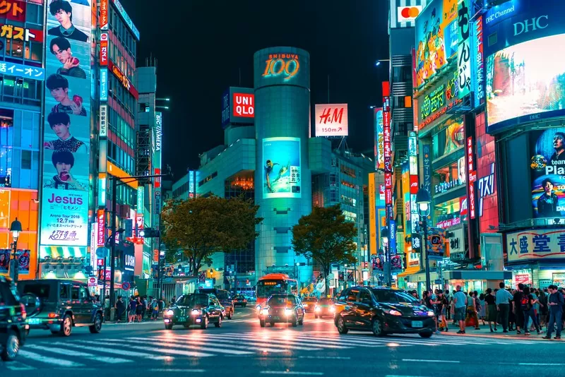 Crowd Outside Shibuya Buildings And Cars, Japan