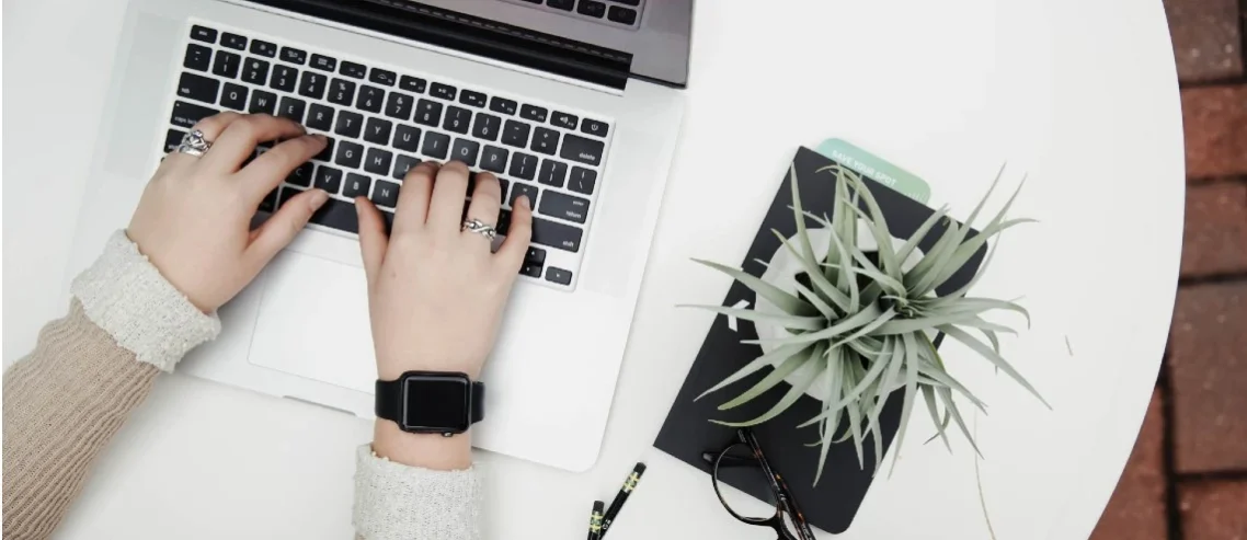 image shows a person using a laptop.