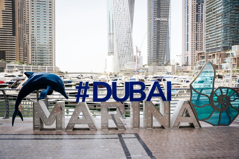 Dubai Marina Sign With Dolphin Statue