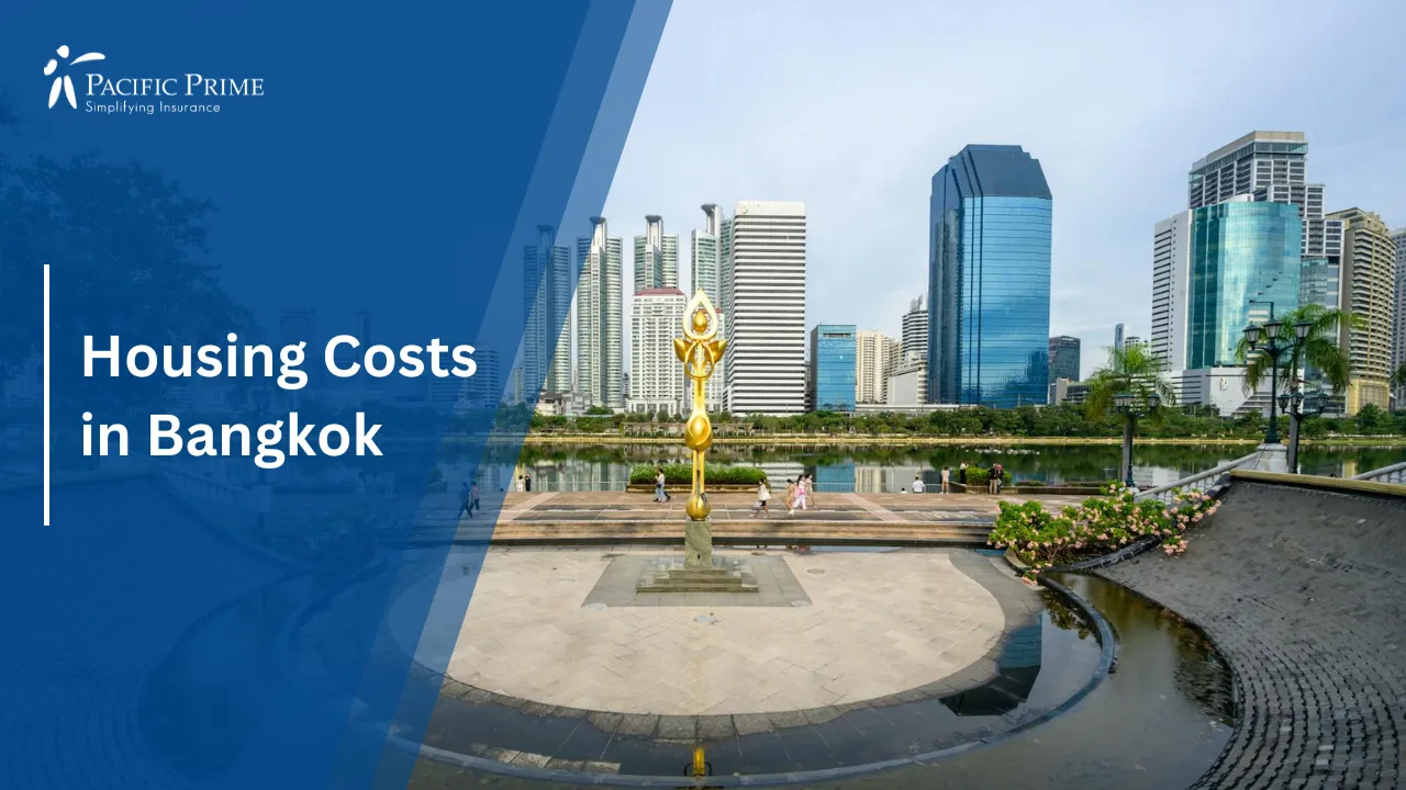 Image of Golden Monument In Urban Park Setting In Bangkok, Thailand with text overlay of "Housing Costs in Bangkok"