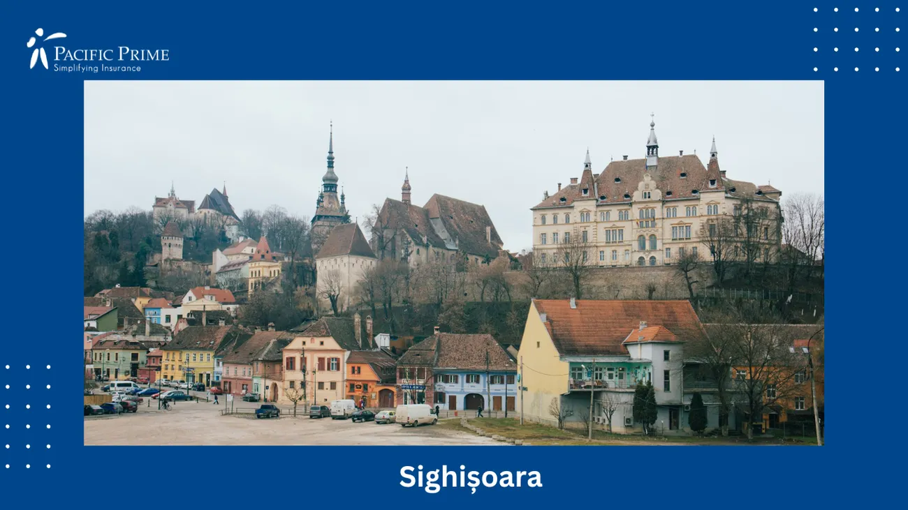 Image of Gothic Beige And Brown Building Atop A Hill In Sighișoara, Romania with text overlay of "Sighișoara"