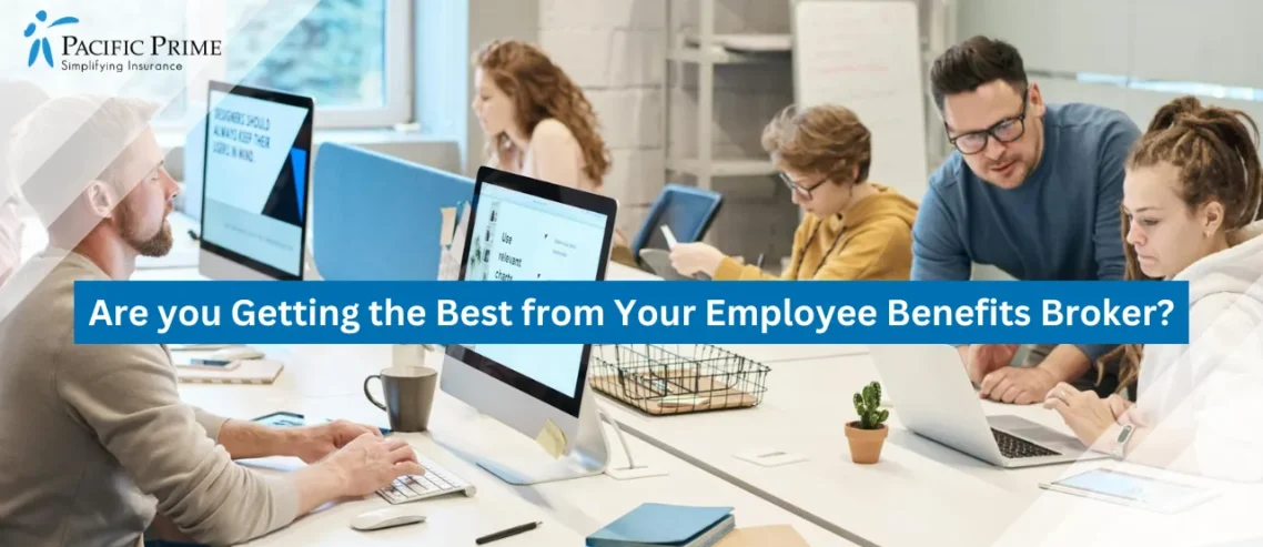 Image of Group Collaborating On Computers In A Modern Office with text overlay of "Are you Getting the Best from Your Employee Benefits Broker?"