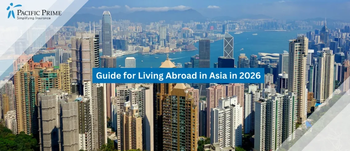 Image of Hong Kong Island Skyline With Clear Blue Skies And Modern Waterfront Towers with text overlay of "Guide for Living Abroad in Asia in 2026"