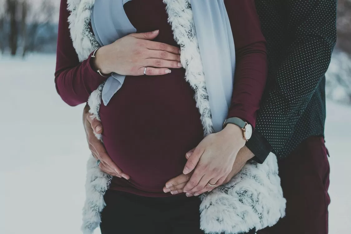 Man Hugging Pregnant Woman From Behind