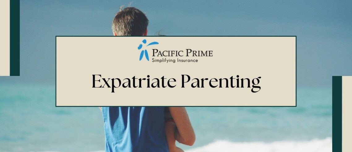 Image of a Man In Blue With Toddler In Black By The Ocean Under Clear Sky with text overlay of "Expatriate Parenting"