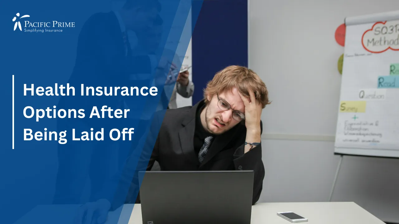 Image of Man Seated At Desk Using A Laptop Computer Indoors with text overlay of "Health Insurance Options After Being Laid Off"