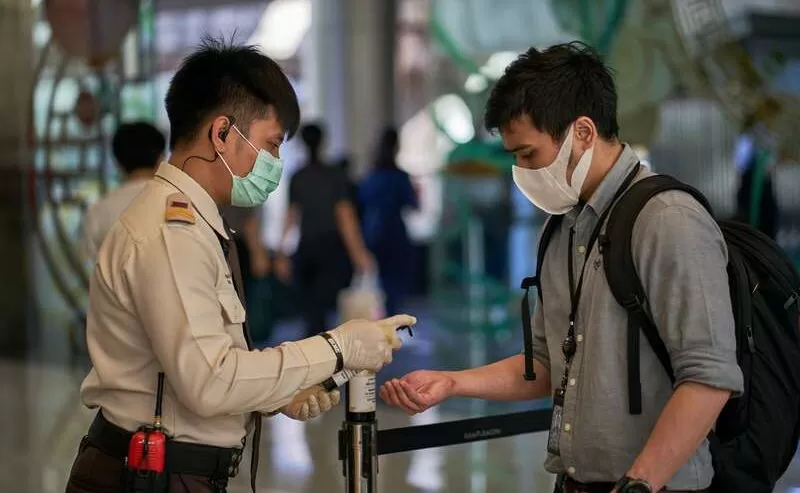Men and Hand Sanitizer in Bangkok: COVID-19 Disinfection