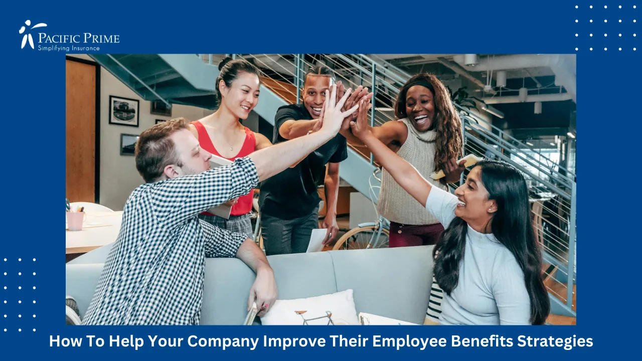 Image of Multicultural Office Team High-fiving In Celebration Of Success with text overlay of "How To Help Your Company Improve Their Employee Benefits Strategies"