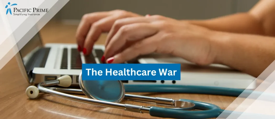 Image of Person Using Laptop Next To A Green Stethoscope On A Desk with text overlay of "The Healthcare War"