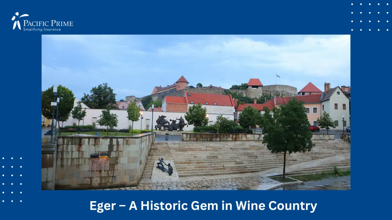 Image of River Flowing Through Eger Cityscape With Tall Buildings, Hungary with text overlay of "Eger – A Historic Gem in Wine Country"