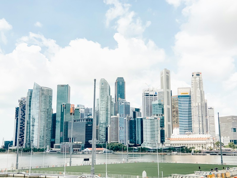 Singapore's Football Field: City Skyline Under Cloudy Day