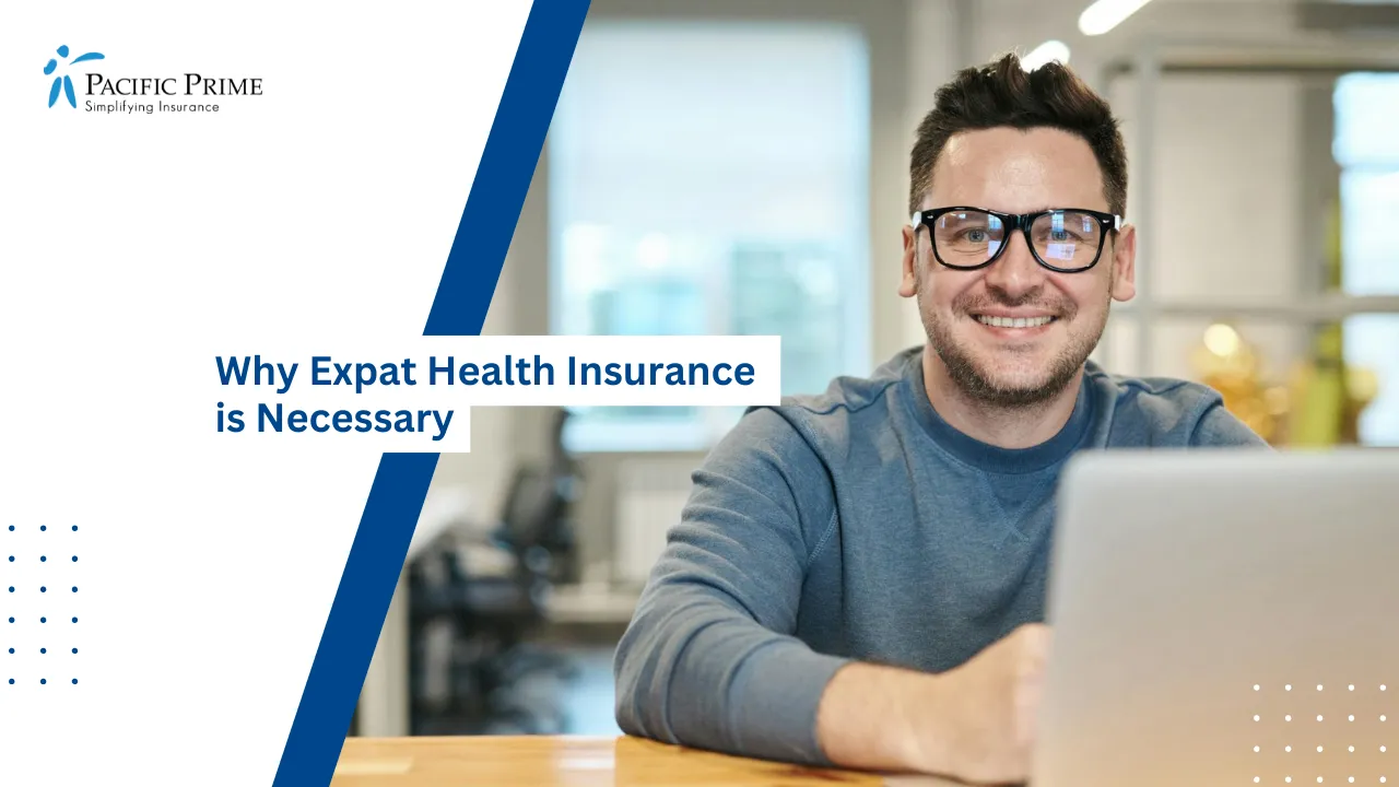 Image of Smiling Man With Glasses Working Remotely On Laptop In Office with text overlay of "Why Expat Health Insurance is Necessary"