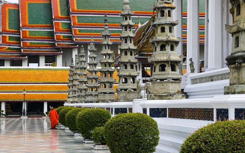 Strolling By Towering Thai Building