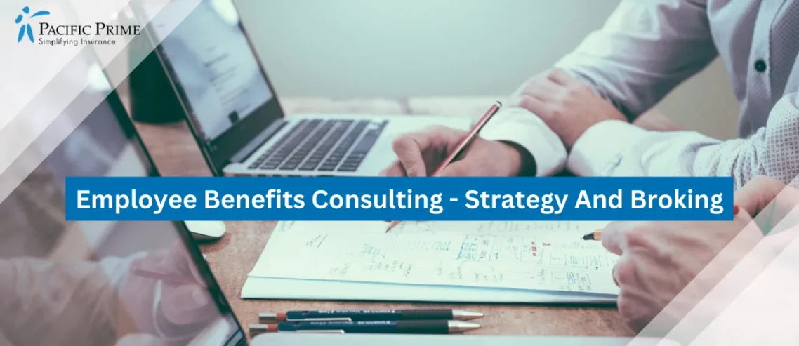 Image of Team Brainstorming Ideas Over Documents At A Table with text overlay of "Employee Benefits Consulting - Strategy And Broking"