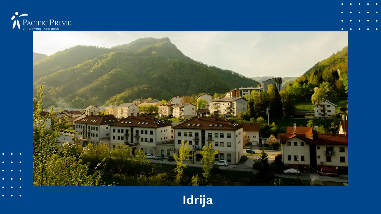 Image of Town With Mountain Backdrop In Spodnja Idrija, Slovenia with text overlay of "Idrija"