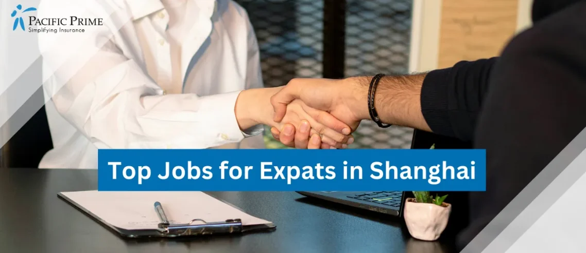 Image of Two Individuals Shaking Hands At A Job Interview with text overlay of "Top Jobs for Expats in Shanghai"