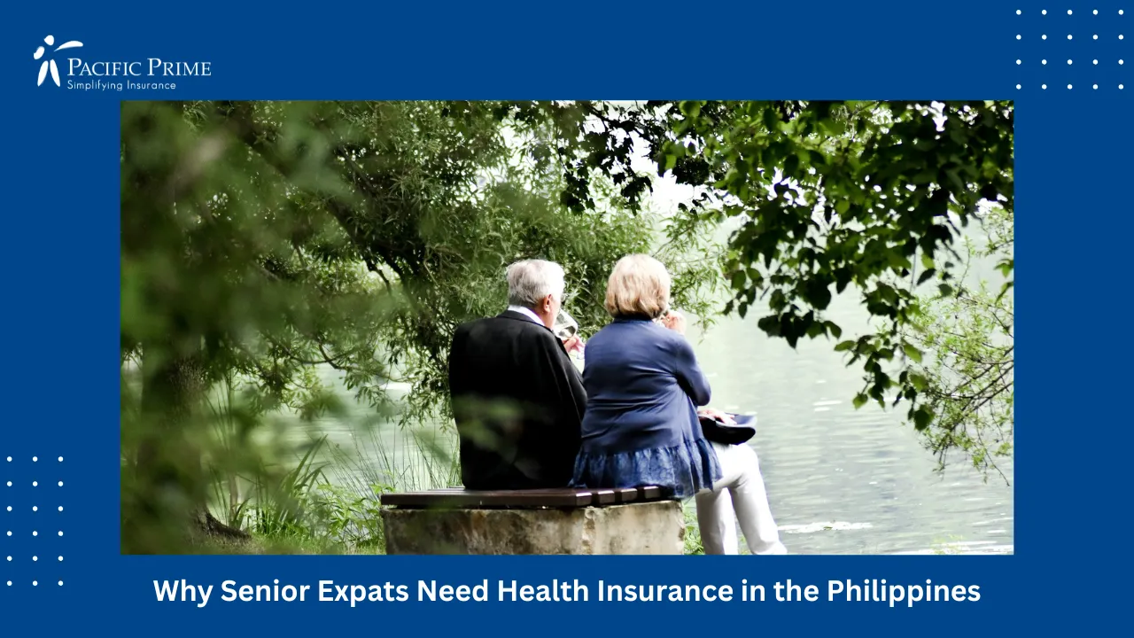 Image of Two People Sitting By The Water's Edge On A Paved Walkway with text overlay of "Why Senior Expats Need Health Insurance in the Philippines"