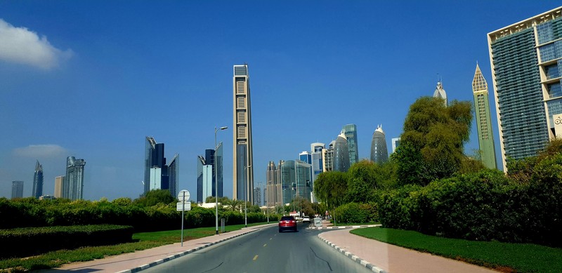 Vehicle on Road Amidst Dubai's High-Rise Buildings, UAE