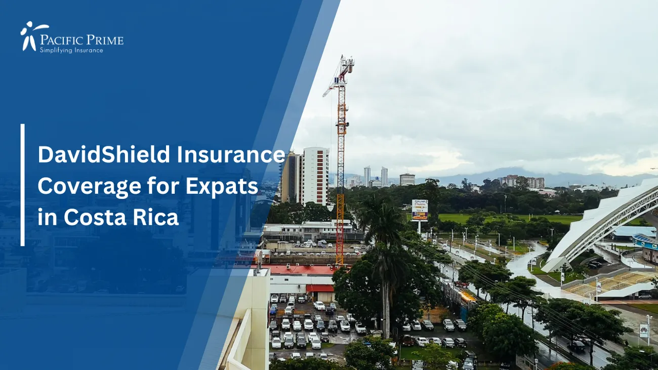 Image of White And Red Building Near Sabana Park With Volcán Irazú In The Distance, Costa Rica with text overlay of "DavidShield Insurance Coverage for Expats in Costa Rica"