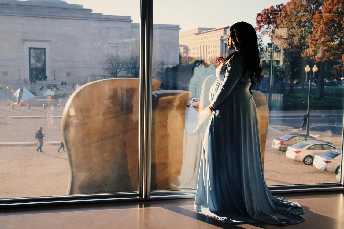 Woman In Black Dress By Glass Window