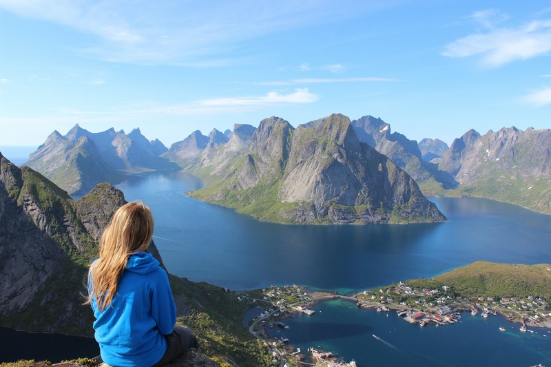 Woman On Cliff Overlooking Lakeside Town, Senior Travel
