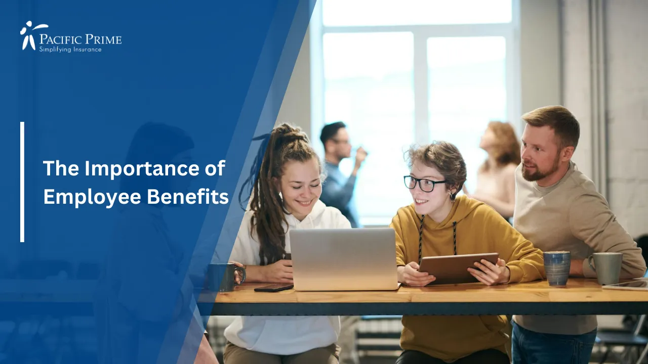 Image of Young Professionals Working Together With Laptops And Tablets Indoors with text overlay of "The Importance of Employee Benefits"